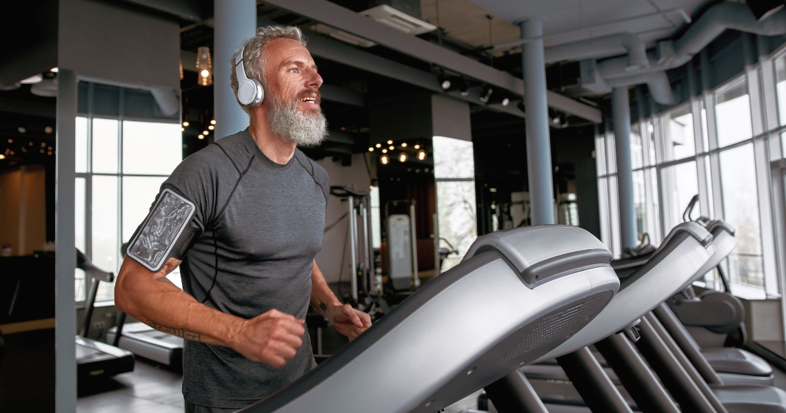 An older man running on a treadmill.