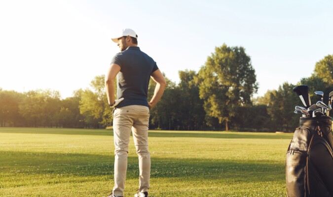 A man playing golf on a nice day.