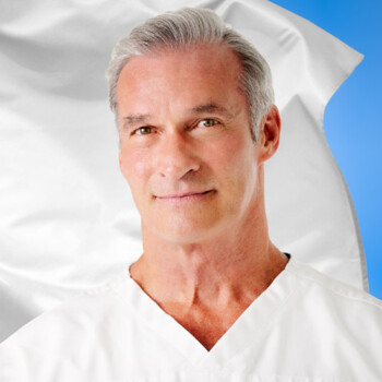 Headshot of Dr. Rand McClain with an Empower Pharmacy flag in the background.