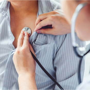 Patient with physician checking heart